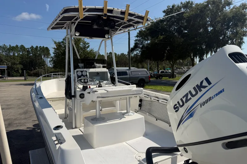 Slide: The Image of 1999 Robalo 2120 Center Console boat with Suzuki Four Stroke engine, parked outdoors. - 10