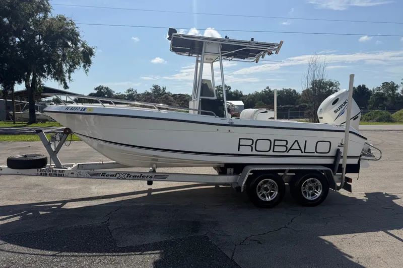 Slide: The Image of 1999 Robalo 2120 Center Console boat on trailer, side view, outdoors. - 5