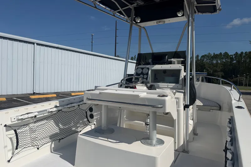 Slide: The Image of 1999 Robalo 2120 Center Console boat with T-top and modern dashboard. - 9