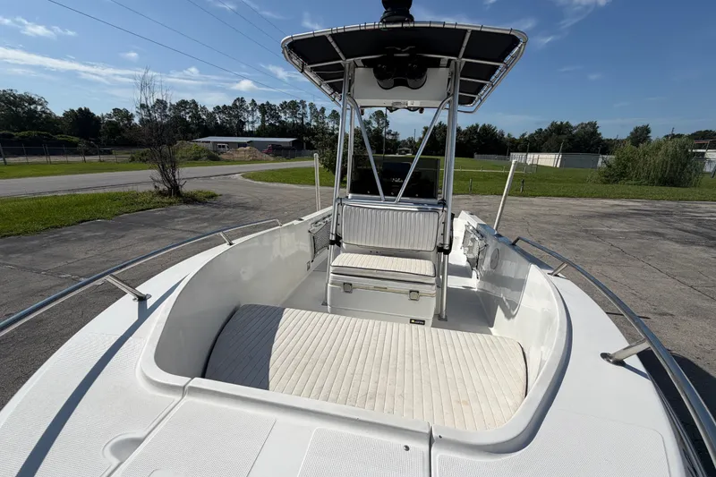 Slide: The Image of 1999 Robalo 2120 Center Console boat with spacious deck and seating, parked outdoors. - 20