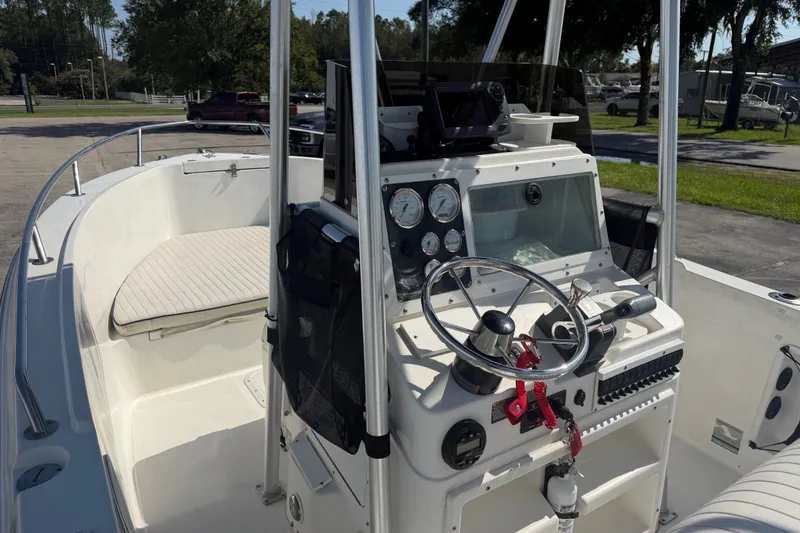 Slide: The Image of 1999 Robalo 2120 Center Console boat interior with steering wheel and gauges. - 12