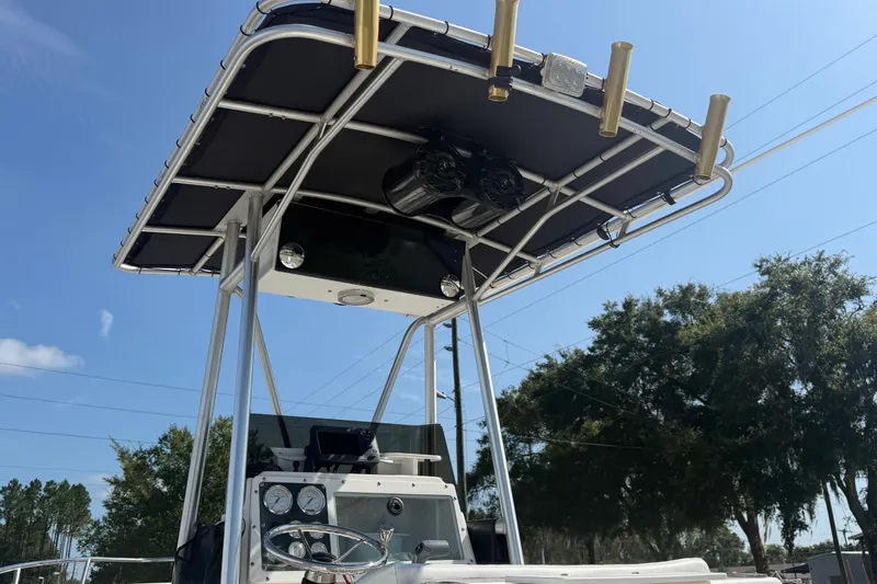 Slide: The Image of 1999 Robalo 2120 Center Console boat with T-top and fishing rod holders. - 14