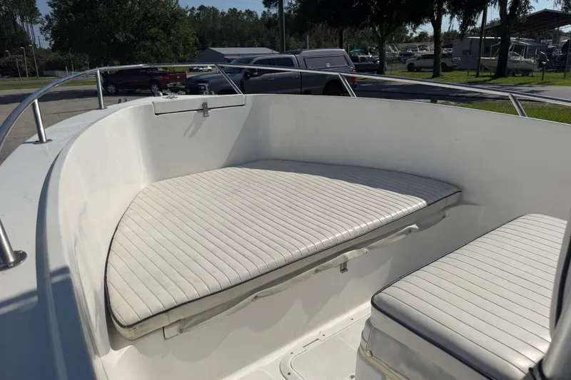 Slide: The Image of 1999 Robalo 2120 Center Console boat with cushioned seating in sunlight. - 13
