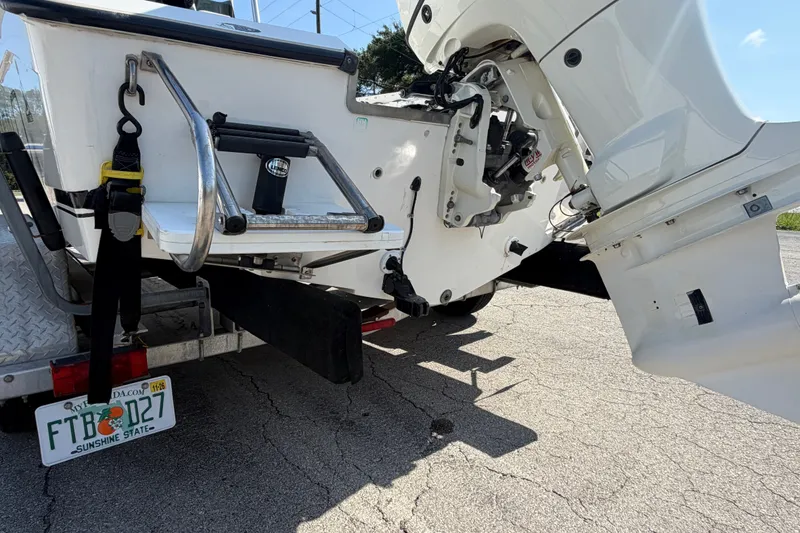 Slide: The Image of 1999 Robalo 2120 Center Console boat on trailer, showing outboard motor and Florida license plate. - 25