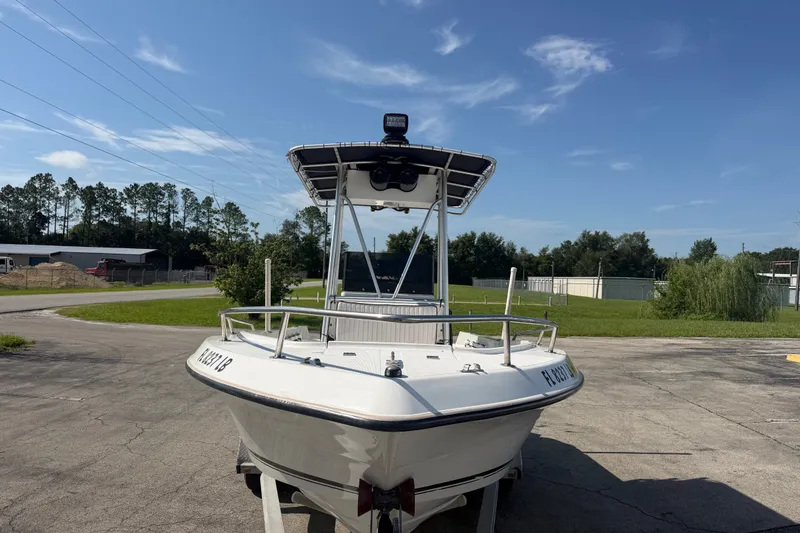 Slide: The Image of 1999 Robalo 2120 Center Console boat on trailer, parked outdoors under clear sky. - 3
