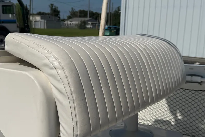 Slide: The Image of White cushioned seat on a 1999 Robalo 2120 Center Console boat. - 23