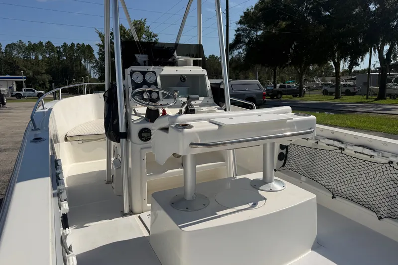 Slide: The Image of 1999 Robalo 2120 Center Console boat with steering wheel and seating, parked outdoors. - 11
