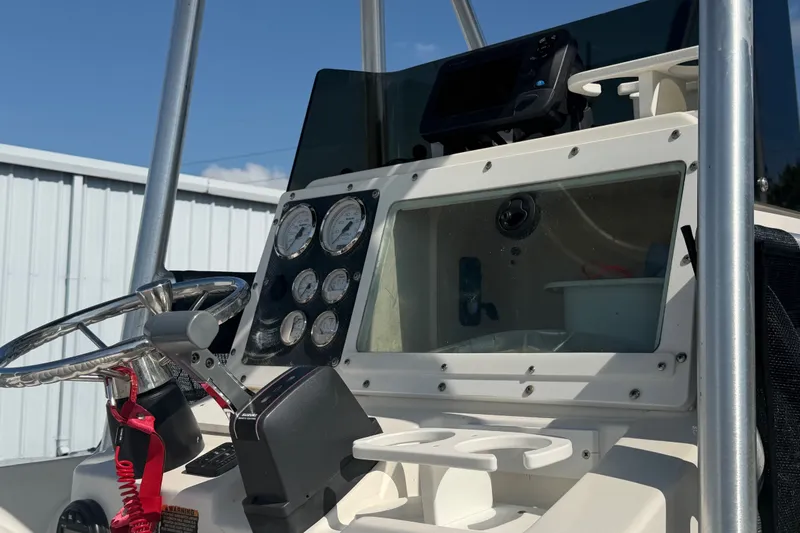 Slide: The Image of 1999 Robalo 2120 Center Console dashboard with gauges and steering wheel. - 21
