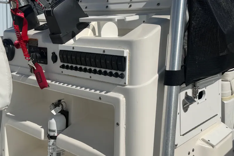 Slide: The Image of 1999 Robalo 2120 Center Console dashboard with controls and safety equipment. - 22