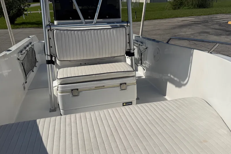 Slide: The Image of 1999 Robalo 2120 Center Console boat interior with cushioned seating and storage. - 17