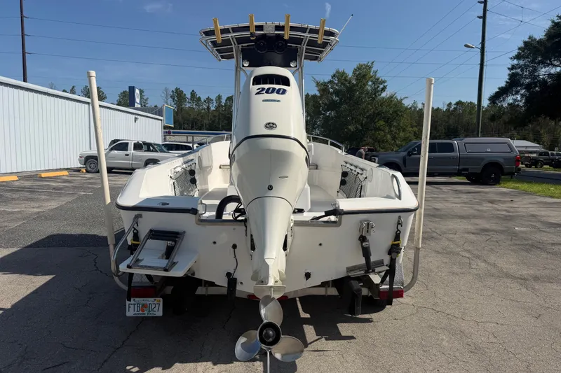 Slide: The Image of 1999 Robalo 2120 Center Console boat with outboard motor, parked outdoors. - 7