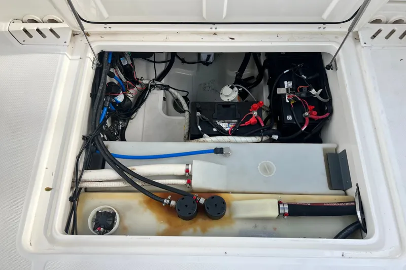 Slide: The Image of 2015 Boston Whaler 270 Vantage engine compartment with wiring and battery setup. - 94