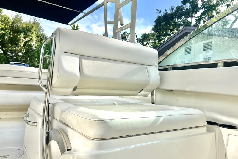 Slide: The Image of 2015 Boston Whaler 270 Vantage boat interior with white cushioned seating and stainless steel frame. - 63