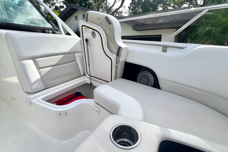 Slide: The Image of 2015 Boston Whaler 270 Vantage interior with white seating and storage compartment. - 70