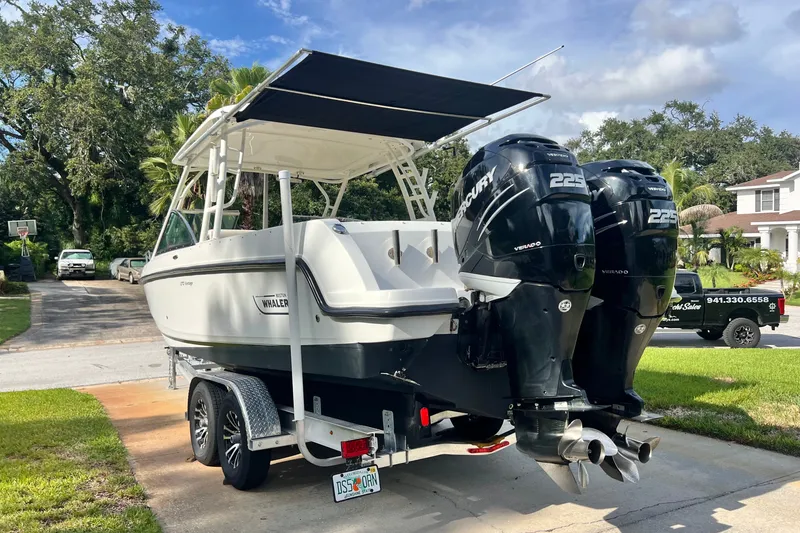 Slide: The Image of 2015 Boston Whaler 270 Vantage boat with twin Mercury 225 engines on a trailer. - 18