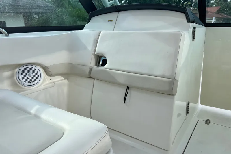 Slide: The Image of Interior of a 2015 Boston Whaler 270 Vantage boat, featuring white seating and speaker. - 83