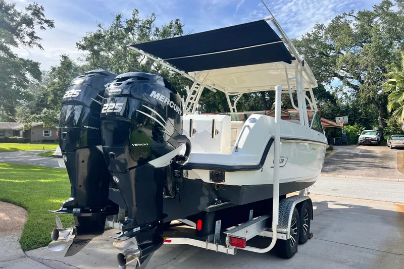 Slide: The Image of 2015 Boston Whaler 270 Vantage boat with twin Mercury 225 engines on a trailer. - 19