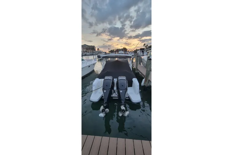 Slide: The Image of 2015 Boston Whaler 270 Vantage docked at sunset with twin engines. - 1