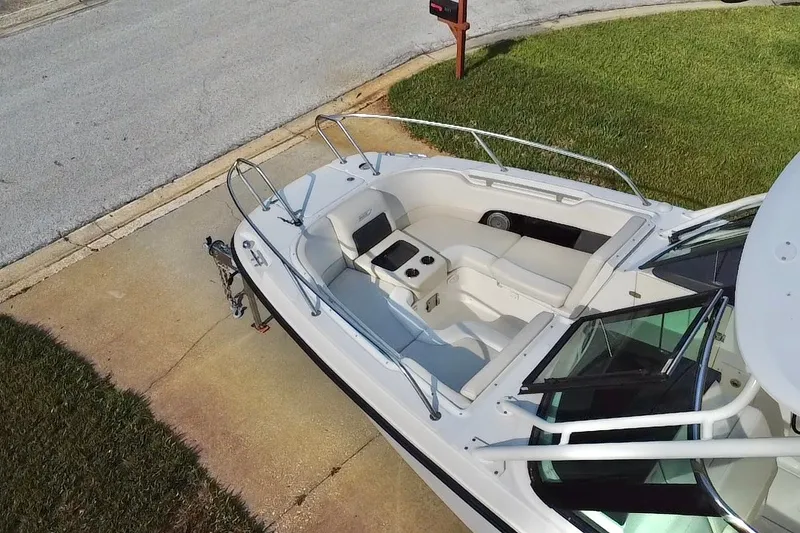Slide: The Image of 2015 Boston Whaler 270 Vantage boat parked on driveway, showcasing spacious seating and sleek design. - 41