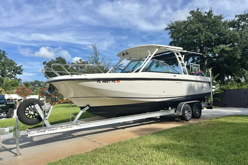 Slide: The Image of 2015 Boston Whaler 270 Vantage boat on trailer, parked outdoors. - 23