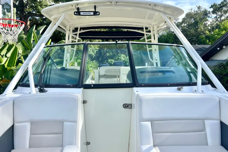 Slide: The Image of 2015 Boston Whaler 270 Vantage boat interior with white seating and windshield. - 51