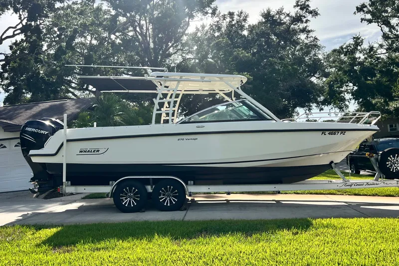 The Image of 2015 Boston Whaler 270 Vantage boat on trailer, parked in driveway, sunny day. - 0