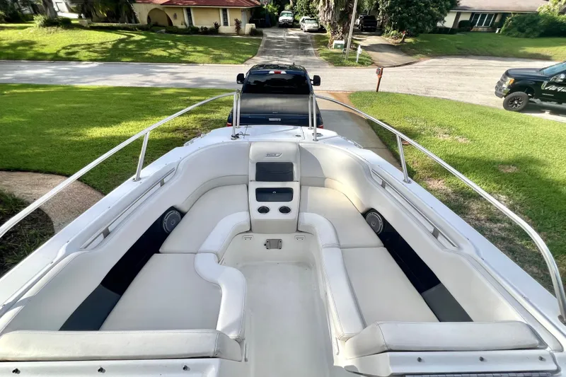 Slide: The Image of 2015 Boston Whaler 270 Vantage boat with spacious seating, parked in a residential area. - 68