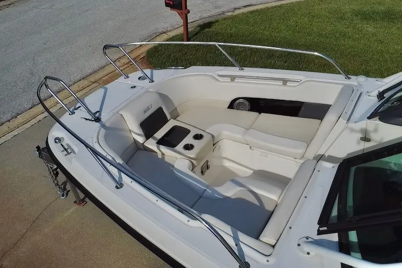 Slide: The Image of 2015 Boston Whaler 270 Vantage boat interior with cushioned seating and cup holders. - 43