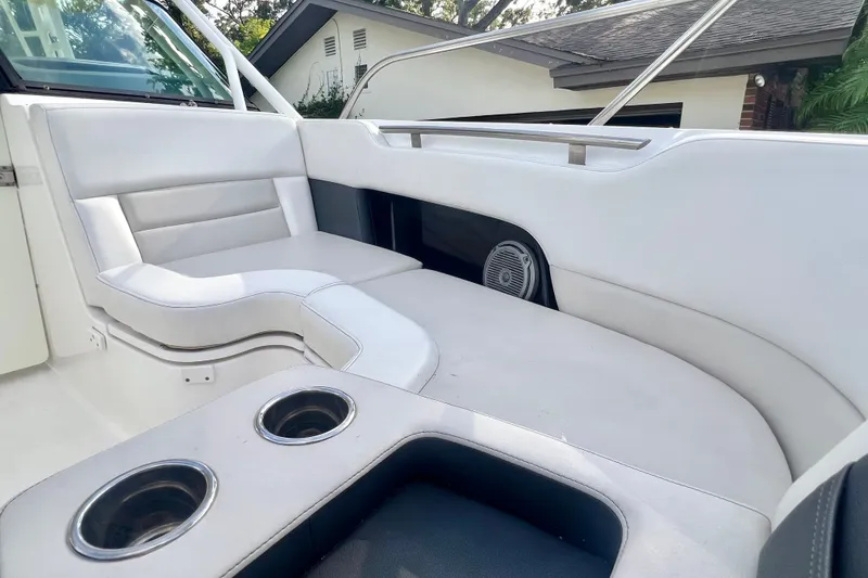 Slide: The Image of 2015 Boston Whaler 270 Vantage interior with white seating and cup holders. - 56