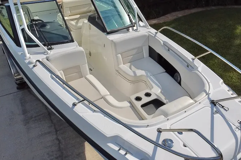 Slide: The Image of 2015 Boston Whaler 270 Vantage boat interior with white seating and cup holders. - 36