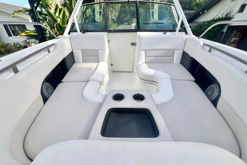 Slide: The Image of 2015 Boston Whaler 270 Vantage boat interior with white seating and cup holders. - 58