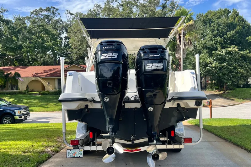 Slide: The Image of 2015 Boston Whaler 270 Vantage with twin 225 Verado engines on a driveway. - 10