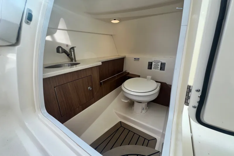 Slide: The Image of 2015 Boston Whaler 270 Vantage boat bathroom with sink and toilet. - 91