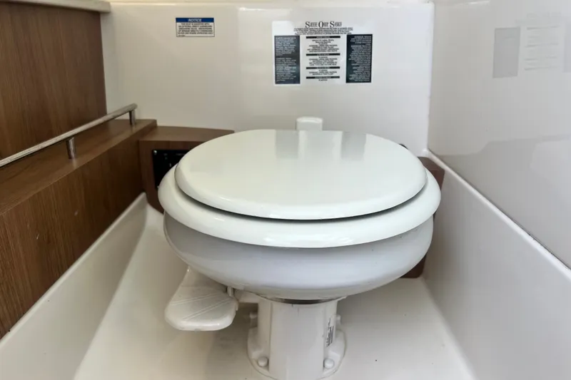 Slide: The Image of Toilet inside 2015 Boston Whaler 270 Vantage boat, featuring a compact marine design. - 89