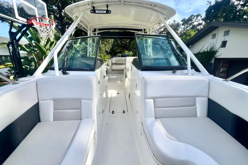 Slide: The Image of 2015 Boston Whaler 270 Vantage boat interior with white seating and open deck. - 52
