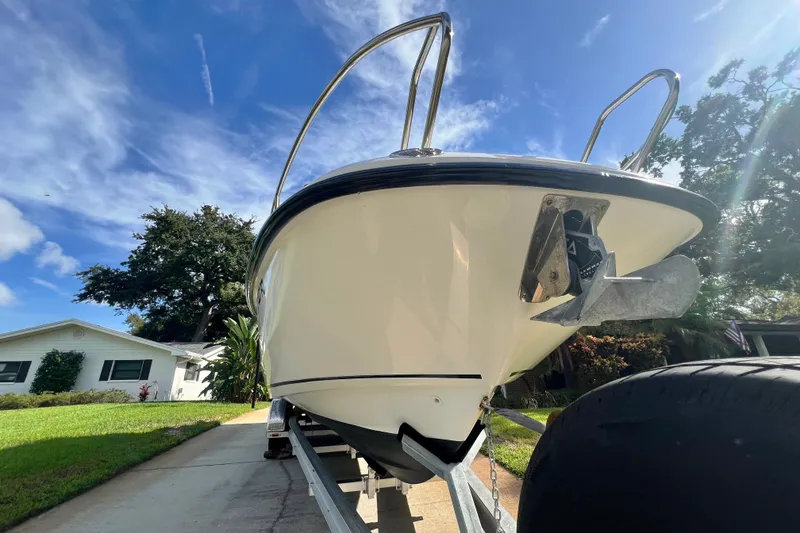 Slide: The Image of 2015 Boston Whaler 270 Vantage boat on trailer, parked in residential driveway. - 2