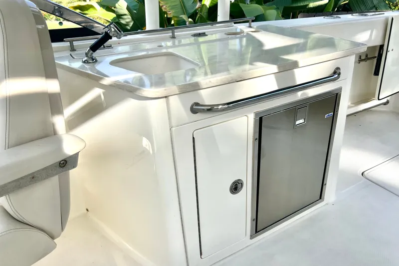 Slide: The Image of 2015 Boston Whaler 270 Vantage boat interior with sink and storage area. - 65