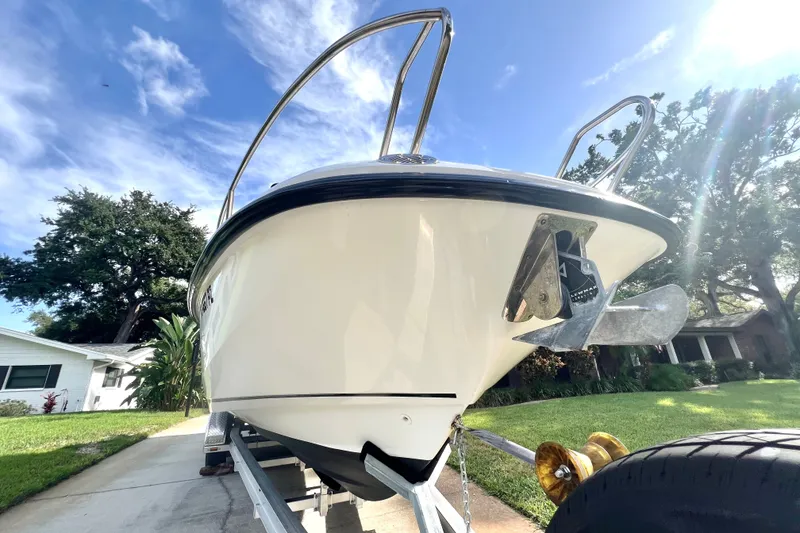 Slide: The Image of 2015 Boston Whaler 270 Vantage boat on trailer, sunny day, residential background. - 21
