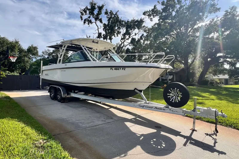 Slide: The Image of 2015 Boston Whaler 270 Vantage boat on trailer in sunny driveway. - 3