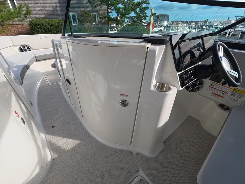 Slide: The Image of The image shows the cockpit of a 2027 Sea Ray SDX 250 Outboard with a modern helm. - 14