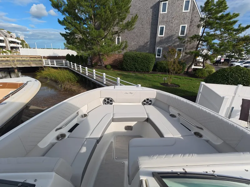 Slide: The Image of The image shows the spacious bow area of a 2027 Sea Ray SDX 250 Outboard with white upholstery. - 18