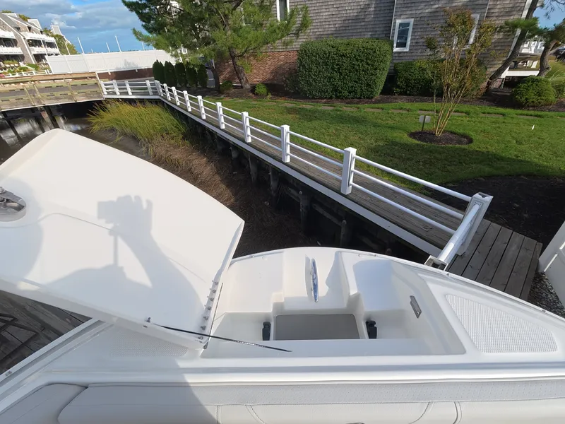 Slide: The Image of The image shows the bow of a Sea Ray SDX 250 Outboard with an open storage hatch. - 21