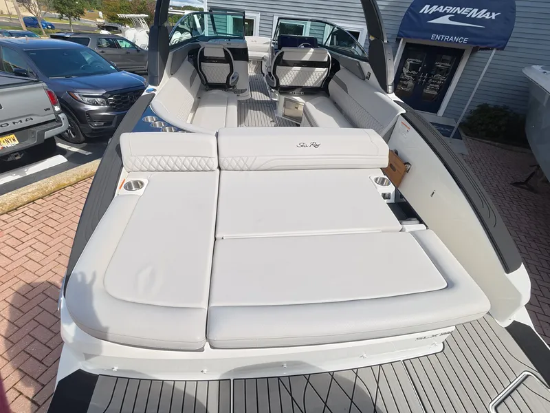 Slide: The Image of The image shows the spacious deck of a 2027 Sea Ray SLX 280 Outboard with sleek white upholstery. - 4