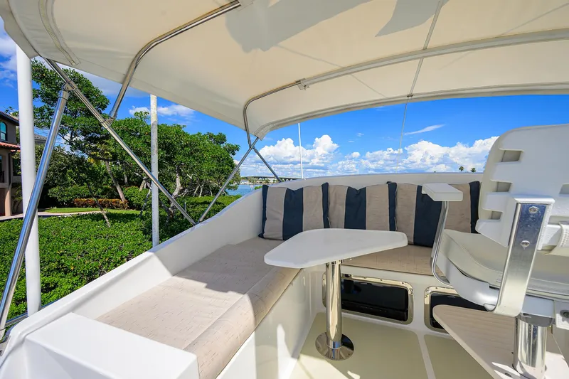 Slide: The Image of 2013 Krogen 44' AE Widebody yacht deck with seating, table, and scenic view. - 39