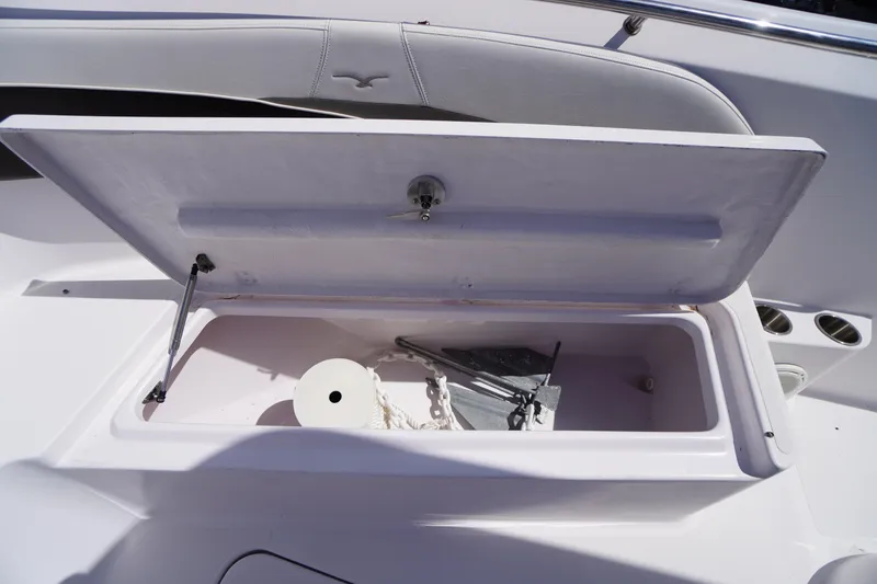 Slide: The Image of Open storage compartment on 2016 Pro-Line 29 Grand Sport boat with anchor and rope. - 14