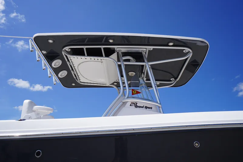 Slide: The Image of 2016 Pro-Line 29 Grand Sport boat with T-top against blue sky. - 1