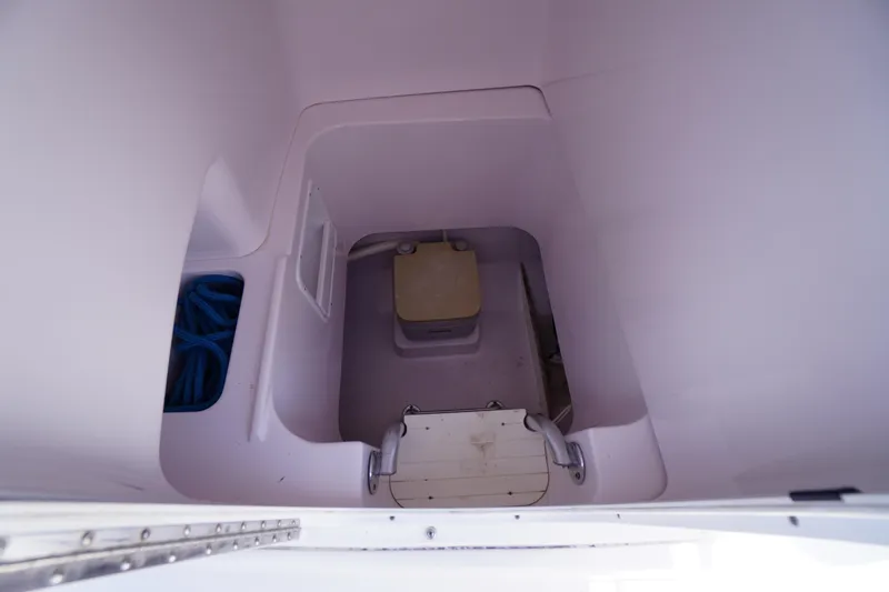 Slide: The Image of Interior of 2016 Pro-Line 29 Grand Sport boat's compact bathroom area. - 24