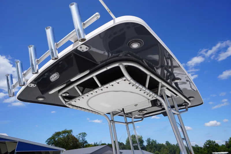 Slide: The Image of 2016 Pro-Line 29 Grand Sport boat's T-top with rod holders against blue sky. - 2