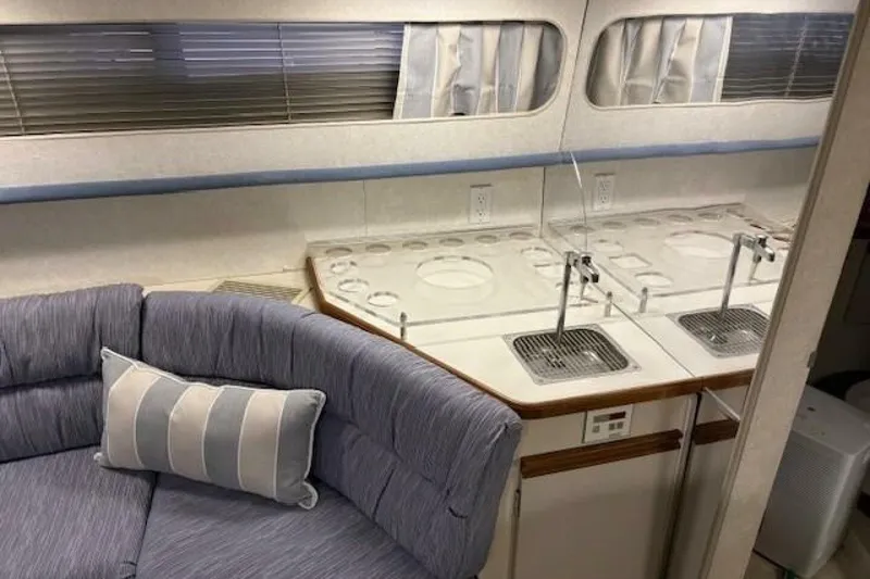 Slide: The Image of Interior of a 1991 Carver 3067 Santego yacht with seating and kitchenette. - 19
