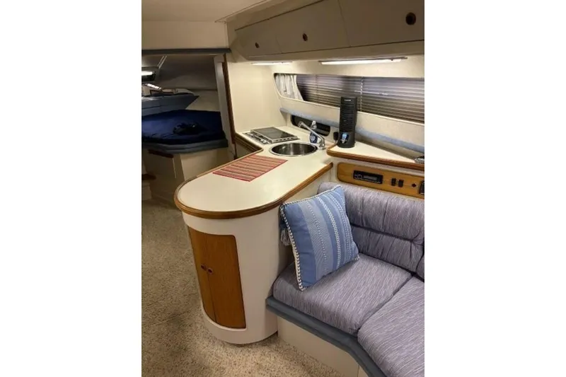 Slide: The Image of Interior of 1991 Carver 3067 Santego yacht with cozy seating and kitchenette. - 18